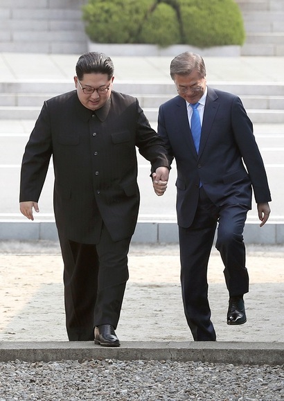 김정은 북한 국무위원장과 문재인 대통령이 손을 잡고 함께 군사분계선을 넘어서 남쪽으로 오고 있다. 사진=한국공동사진기자단