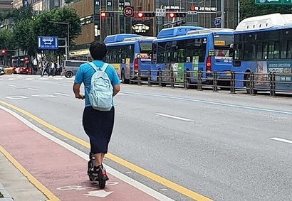 한 시민이 헬멧을 착용하지 않고 전동킥보드를 몰고 있다. 10일부터 시행된 도로교통법 개정안에 따라 4개월 후 법이 다시 개정되면 헬멧을 쓰지 않은 이용자는 적발 시 2만 원의 과태료를 내야 한다. 사진=박찬웅 기자