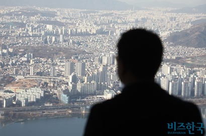 서울 송파구 잠실롯데월드타워 전망대에서 시민이 서울 강남 일대 아파트를 내려다보는 모습. 사진=박정훈 기자